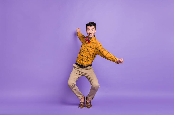 Full length photo of young excited man happy positive smile have fun isolated over purple color background - Фото, изображение