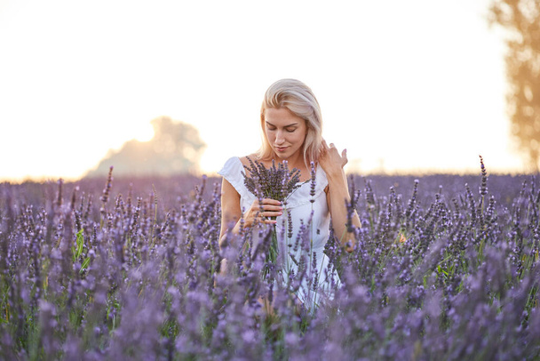 Girl in the lavender field at sunset - Fotó, kép