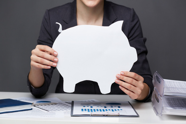 Businesswoman holding paper piggy - Photo, Image