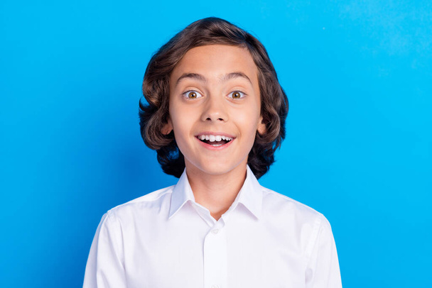 Photo of handsome impressed schoolboy wear formal clothes open mouth smiling isolated blue color background - Fotografie, Obrázek