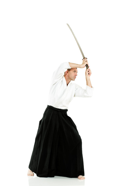 Mid-adult man dressed in traditional kimono demontrating martial arts combat - Photo, Image