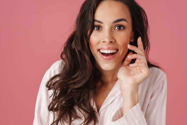 Delighted beautiful woman expressing surprise on camera isolated over pink background - Photo, image
