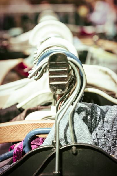 kleding op een rek op een vlooienmarkt - Foto, afbeelding