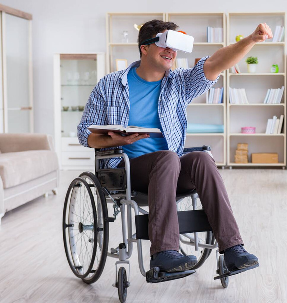 Disabled student studying with virtual reality glasses - 写真・画像