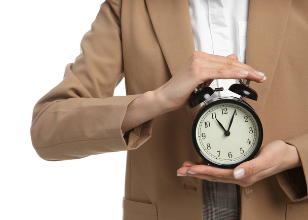 Businesswoman holding alarm clock on white background, closeup. Time management - Фото, изображение