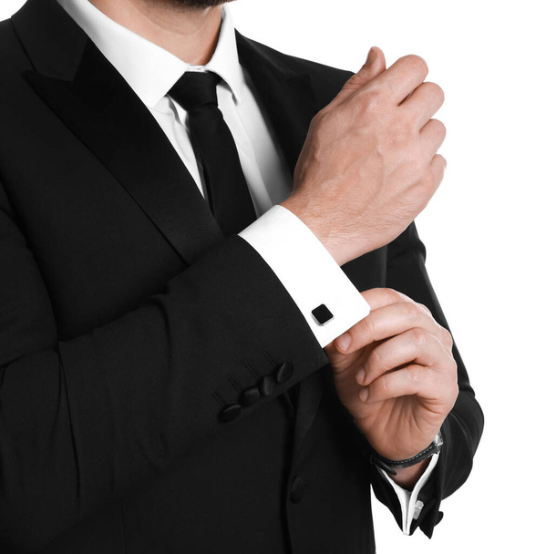 Man wearing stylish suit and cufflinks on white background, closeup - Foto, Imagem