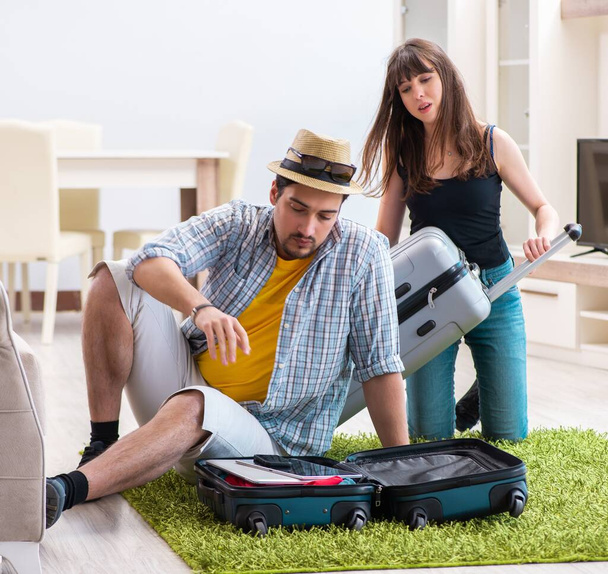 Young family packing for vacation travel - Photo, Image