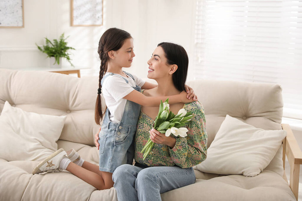 Little daughter congratulating her mom at home. Happy Mother's Day - Фото, изображение