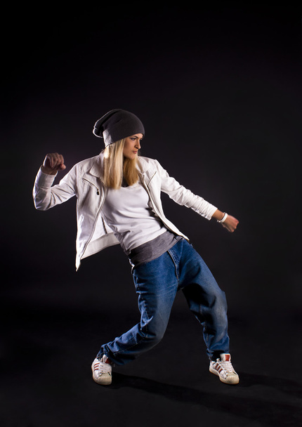 Modern dance, hip hop girl dancer on a black background. - Foto, Imagen
