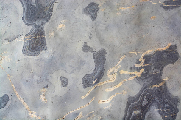 The background is gray stone, with gold veins, abstract pattern, texture of digital wall tile design. - 写真・画像