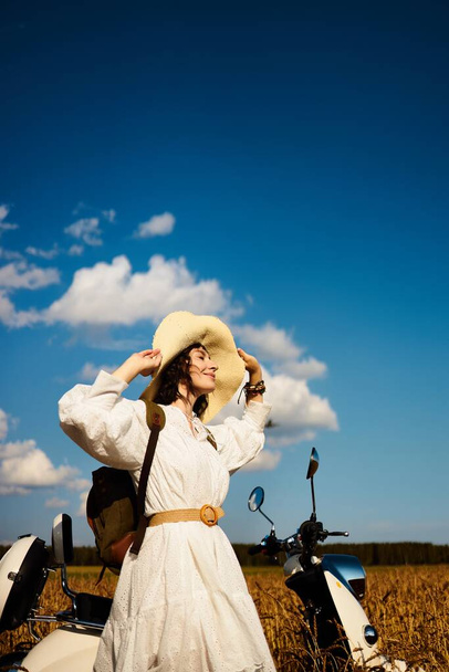 A woman in a wheat field enjoys summer - 写真・画像