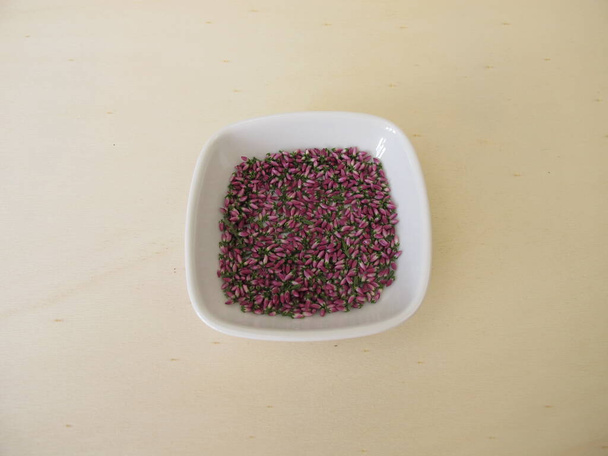 Dried pink heather flowers on a wooden board - Photo, Image
