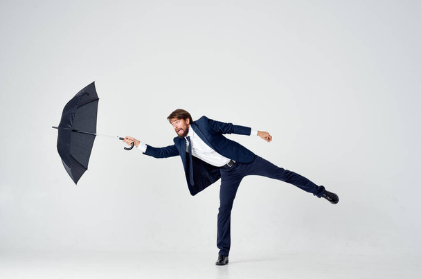 business man in suit  with umbrella in  studio. High quality photo - Zdjęcie, obraz