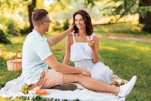 happy couple having picnic at summer park - Фото, изображение