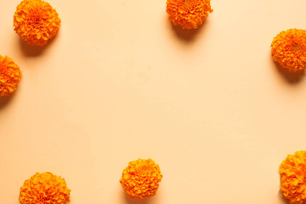 Marigold yellow flowers on orange pastel background, creative flat lay, copy space. Chinese mid autumn festival concept with marigolds. - Photo, Image