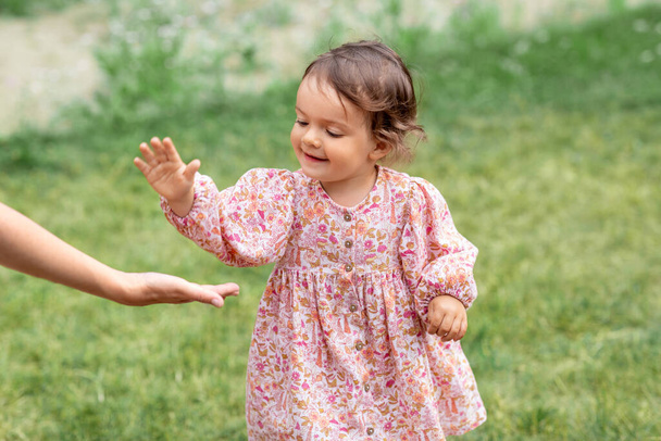 happy smiling baby girl giving hand to adult - Valokuva, kuva