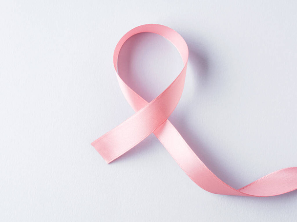 Breast cancer awareness pink ribbon symbol on gray background - Zdjęcie, obraz