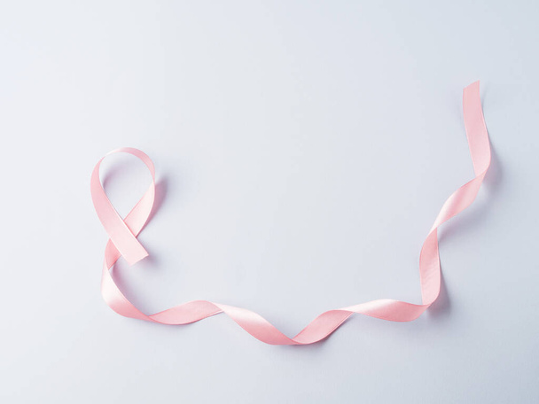 Breast cancer awareness pink ribbon symbol on gray background - Valokuva, kuva