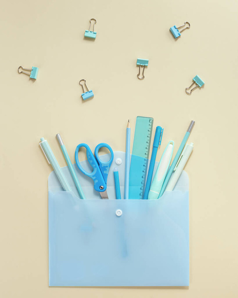 Back to school creative background. Open envelope and school supplies, pencils, pens, rulers, blue and yellow pastel colored. - Valokuva, kuva