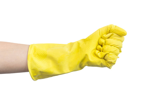 Guante de mano en goma amarilla en gesto de puño apretado, aislado sobre una foto de fondo blanco  - Foto, Imagen