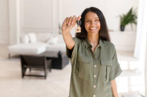 Keys with keychain in form of small cute house in hand of indian female - Photo, image