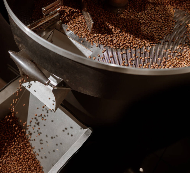 Brown coffee beans in cooling tray of coffee roasting machine - Photo, Image