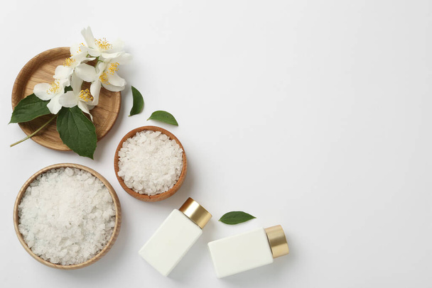 Flat lay composition with beautiful jasmine flowers, sea salt and skin care products on white background, space for text - Fotoğraf, Görsel
