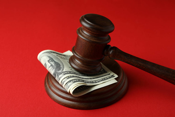 Judge gavel with dollars on red background - Photo, Image