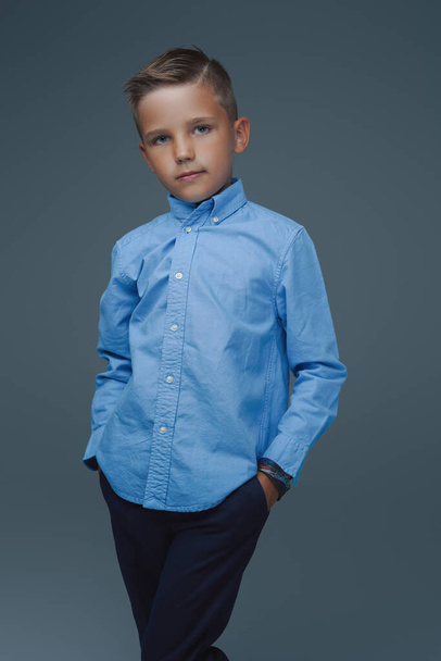 Stylish preschool kid posing against gray background - Фото, зображення