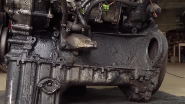 Internal combustion engine, diesel, close-up. He's covered in black oil. - Footage, Video