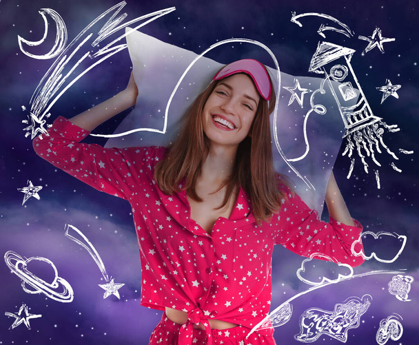Beautiful woman in pajamas with pillow dreaming about space and night starry sky on background  - Φωτογραφία, εικόνα