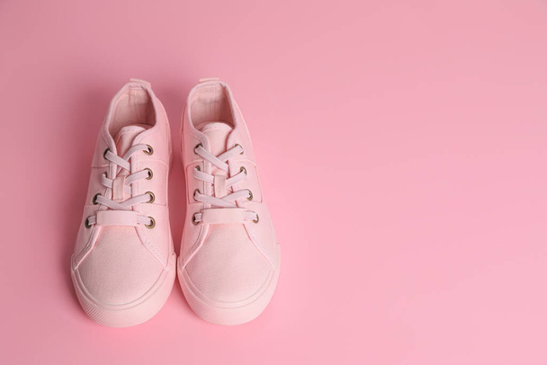 Pair of stylish canvas shoes on pink background. Space for text - Fotoğraf, Görsel
