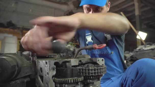 View of disassembled car engine. hands of mechanic repairing engine - Footage, Video