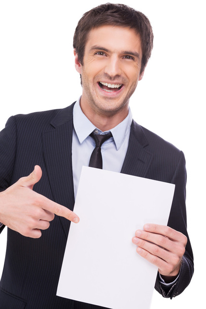Man in formalwear holding blank paper - Foto, afbeelding