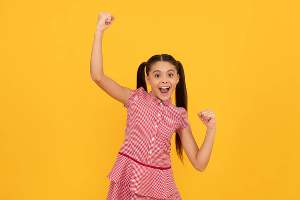 Feel like a winner. Lucky winner yellow background. Happy kid scream making winning gesture - Photo, Image