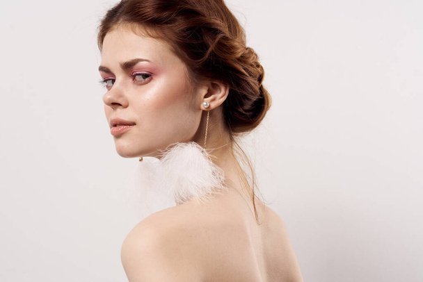 woman with bare shoulders fluffy earrings fashion close up - Photo, Image