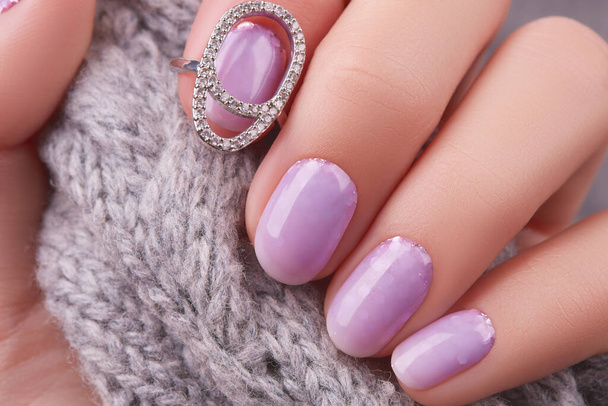 Womans hand with fashionable lavender manicure. Winter christmas nail design - Photo, Image