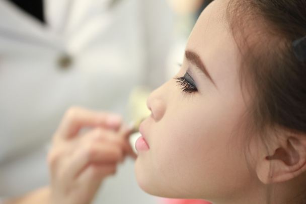 Little girl applying make up. - Photo, Image