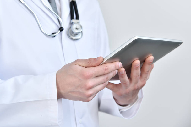 Doctor holding touch pad computer in hand. Healthcare and medicine concept. Close up - Fotografie, Obrázek