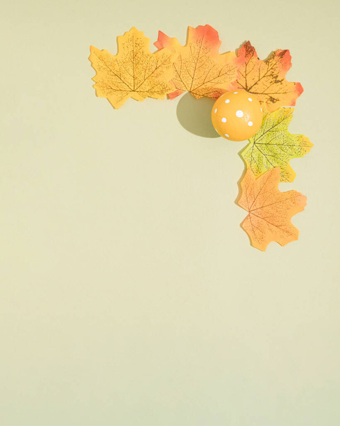 Autumn composition. Frame made of autumn leaves and mashroom on pastel green background. Flat lay, top view, copy space. - Photo, Image