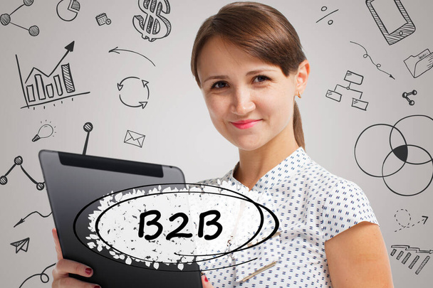 Business, Technology, Internet and network concept. Young businessman working on a virtual screen of the future and sees the inscription: B2B - Foto, Imagem