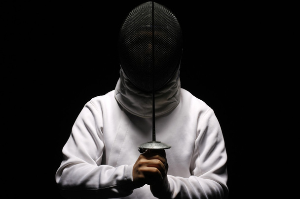 Fencing man with sword isolated on black - Foto, Imagem