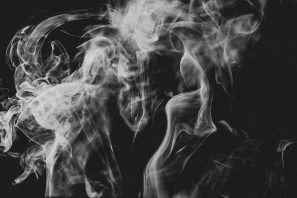 Fluffy Puffs of Smoke and Fog on Black Background - Photo, Image