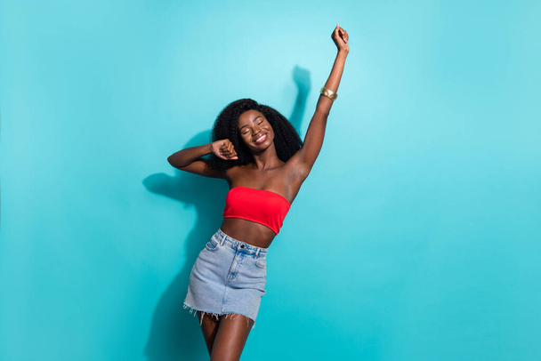 Photo of charming afro american young woman good mood dance dream isolated on teal color background - Foto, Imagem