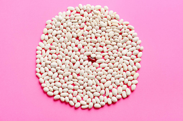 Red bean among white ones on color background. Concept of uniqueness - Fotó, kép