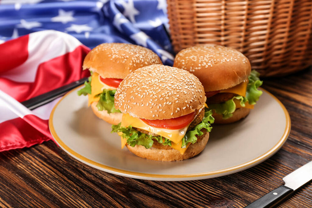 Burgers with American flag on wooden background - Фото, зображення