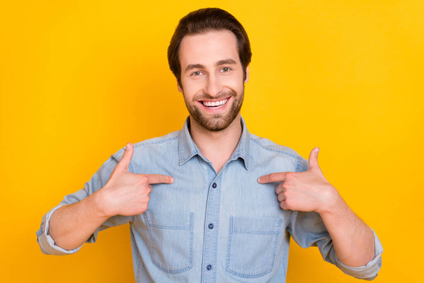 Photo portrait of young guy smiling confident pointing at herself isolated on bright yellow color background - Fotó, kép