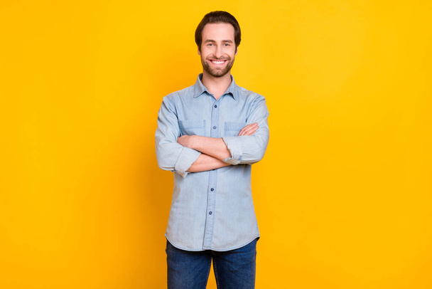 Photo of young handsome man happy positive smile confident crossed hands isolated over yellow color background - Foto, immagini