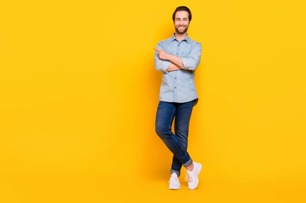 Full body photo of young cheerful man happy positive smile point finger empty space ad advice isolated over yellow color background - Φωτογραφία, εικόνα
