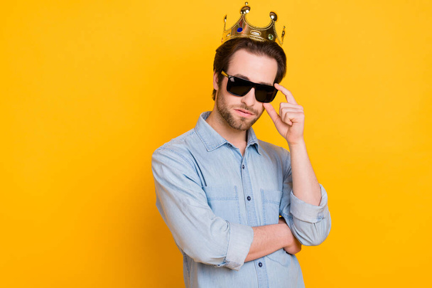 Profile side photo of young serious man hand touch glasses royalty prince isolated over yellow color background - 写真・画像
